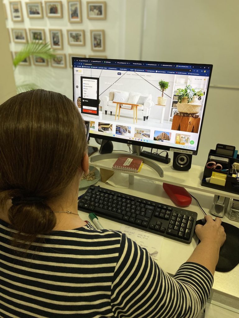 Wereal agent managing the portfolio of properties for sale in Alicante from her computer