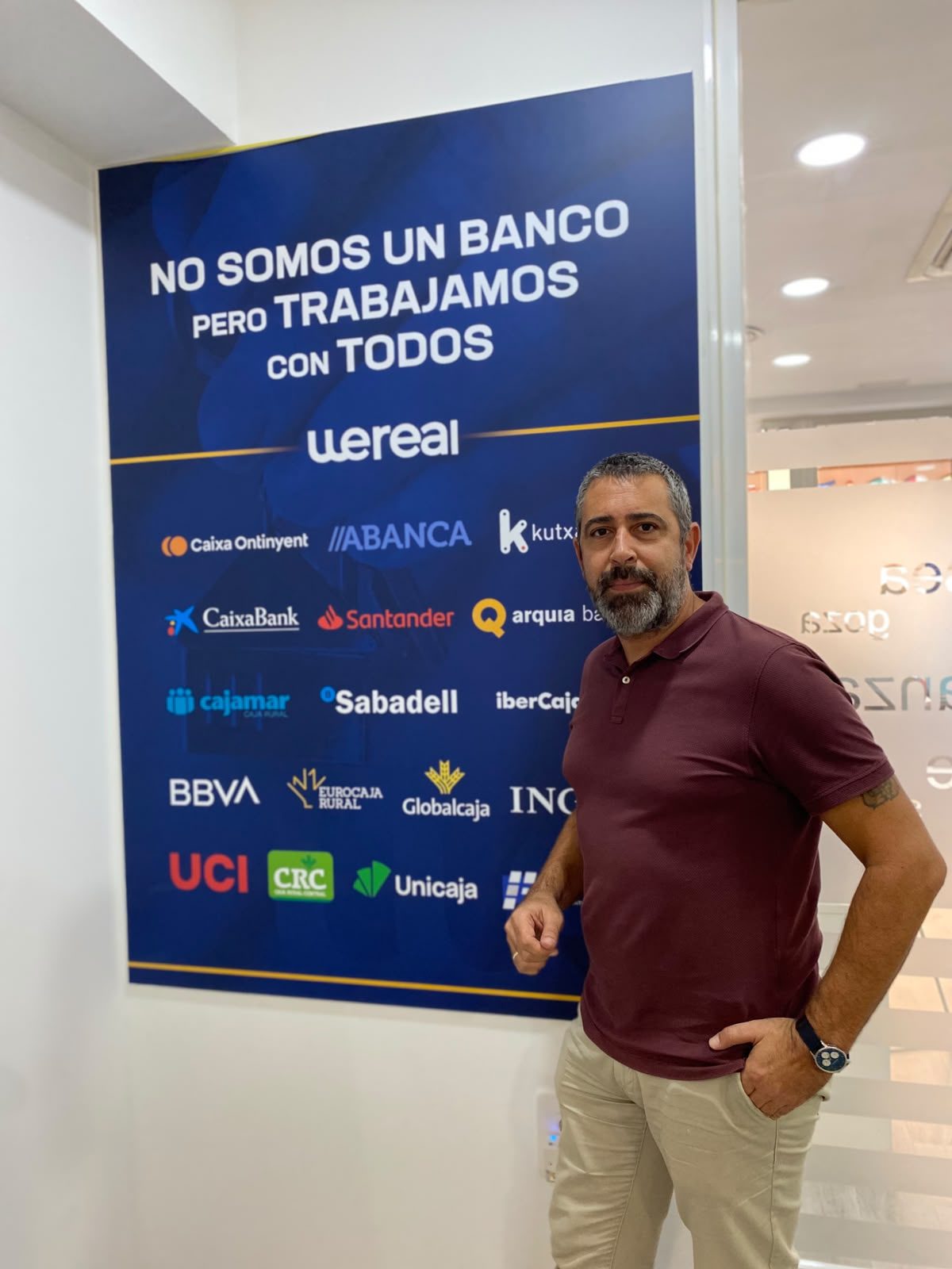 WeBroker mortgage adviser next to the board of banks Wereal works with, in Alicante