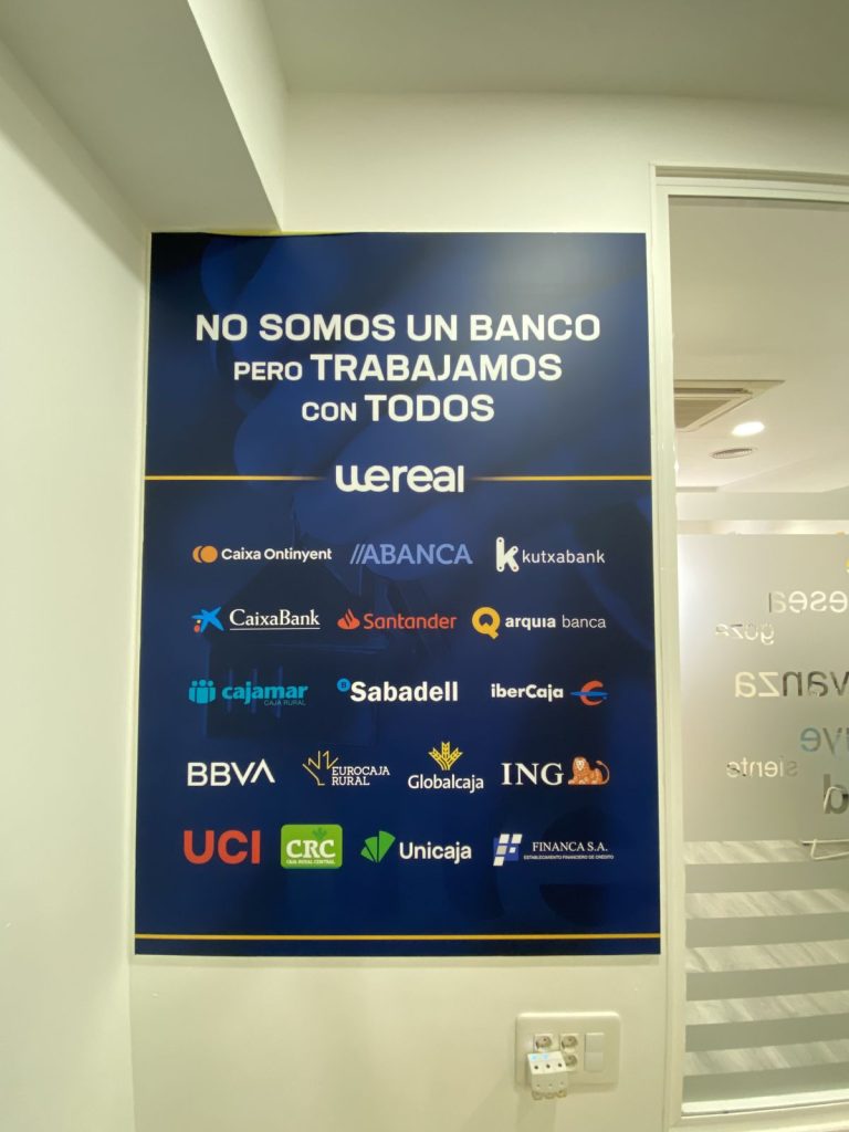 Poster "We are not a bank but we work with all of them" showing the lenders Wereal works with